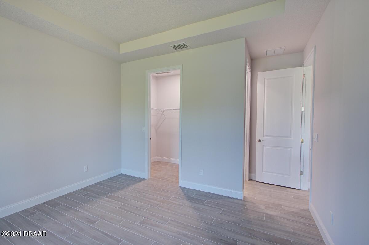 8 Finch Walk Road Ormond Beach, FL 32174 - Photo 9 of 18 a view of an empty room with wooden floor