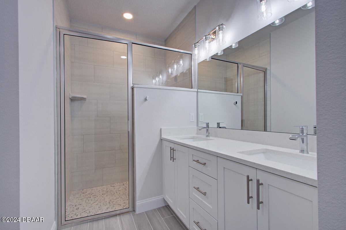 8 Finch Walk Road Ormond Beach, FL 32174 - Photo 10 of 18 a bathroom with a shower sink and mirror