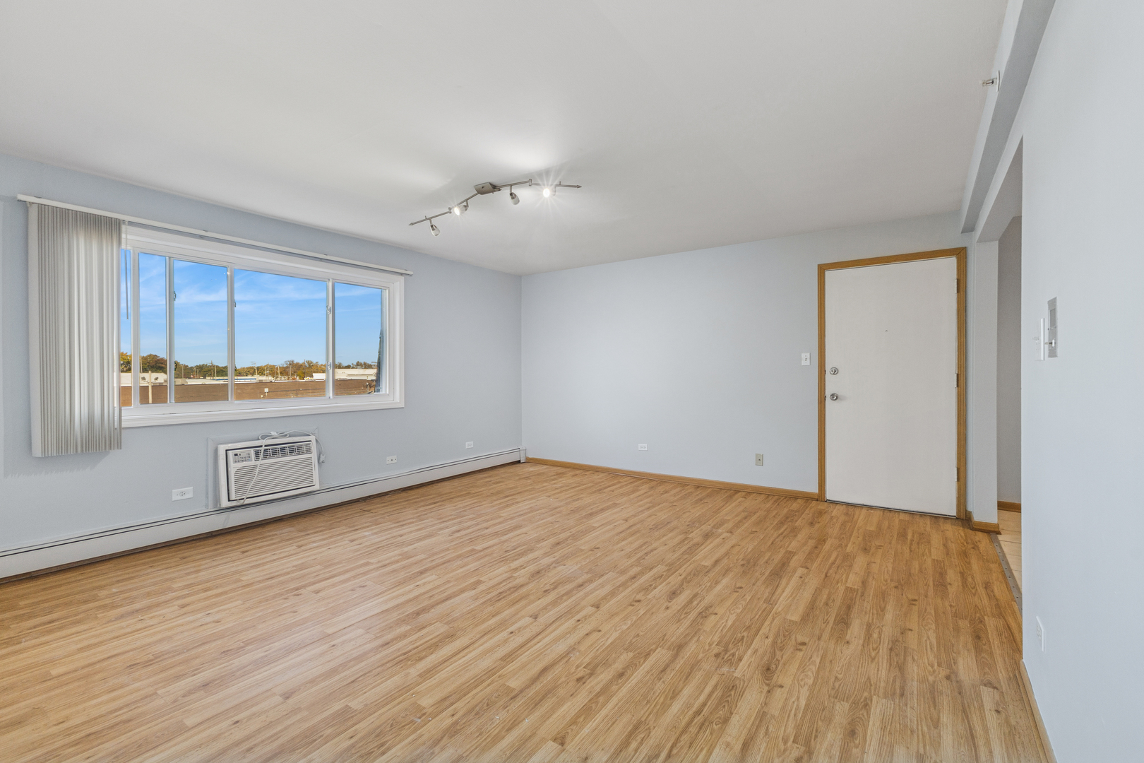 17220 71st Avenue, Unit 11 Tinley Park, IL 60477 - Photo 20 of 20 a view of an empty room with a window and wooden floor