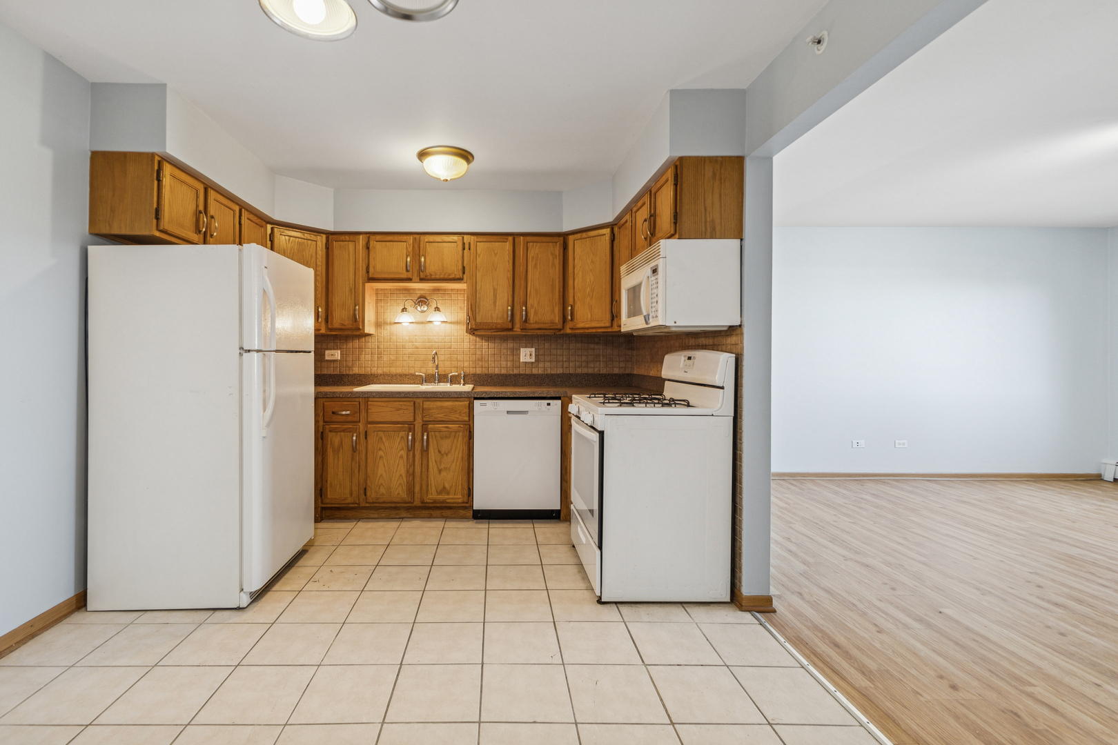 17220 71st Avenue, Unit 11 Tinley Park, IL 60477 - Photo 6 of 20 a kitchen with a refrigerator sink and cabinets