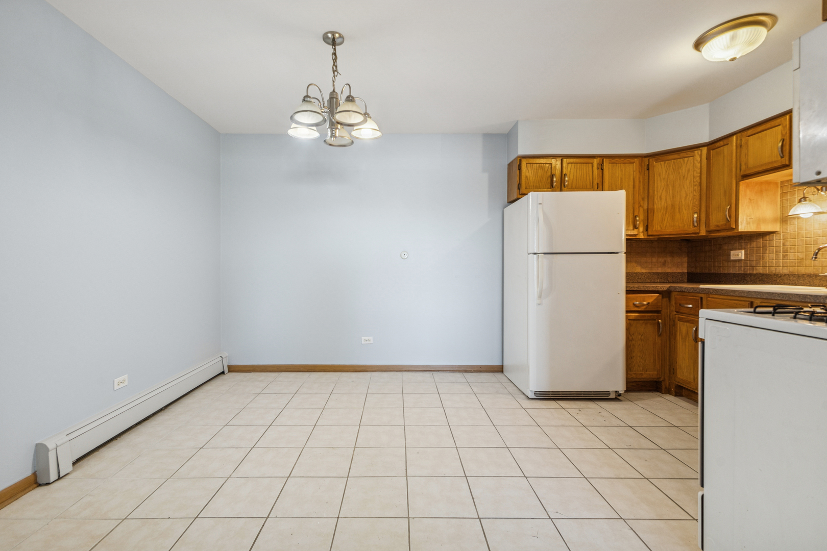 17220 71st Avenue, Unit 11 Tinley Park, IL 60477 - Photo 10 of 20 a view of kitchen and empty room with windows