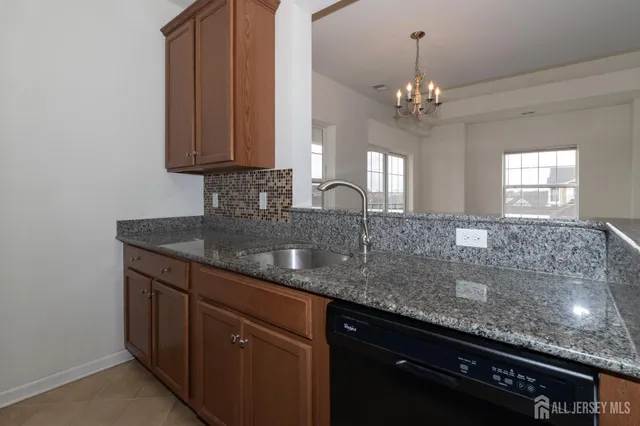 a kitchen with granite countertop a stove and a microwave