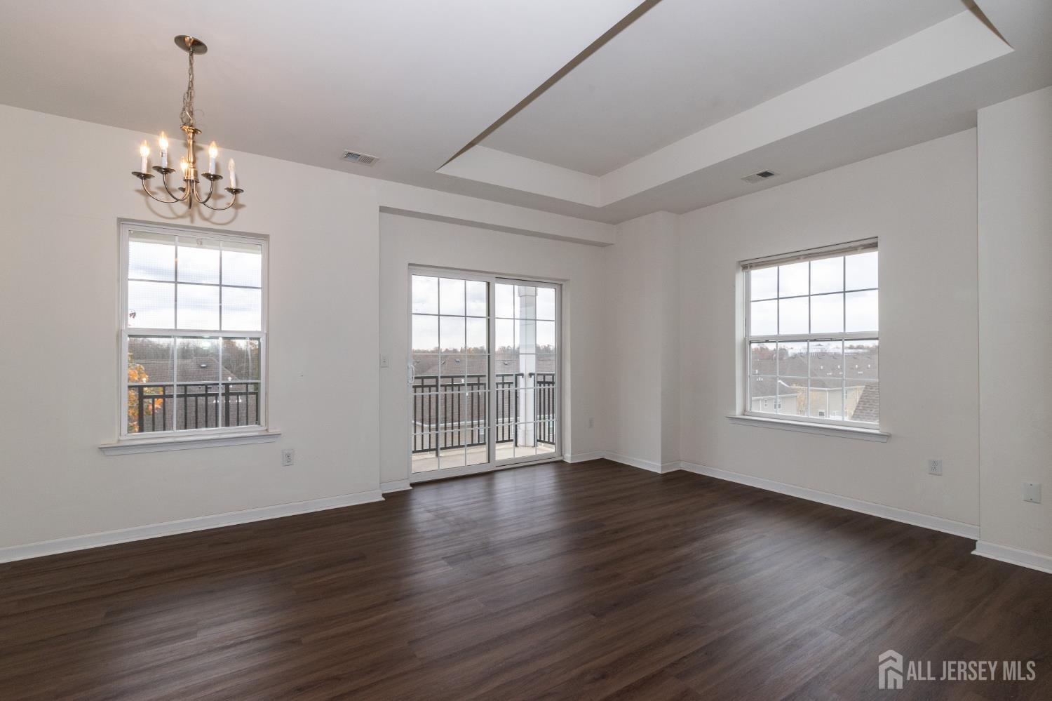 541 East Celebration Way South Plainfield, NJ 07080 - Photo 14 of 35 a view of an empty room with wooden floor and a window