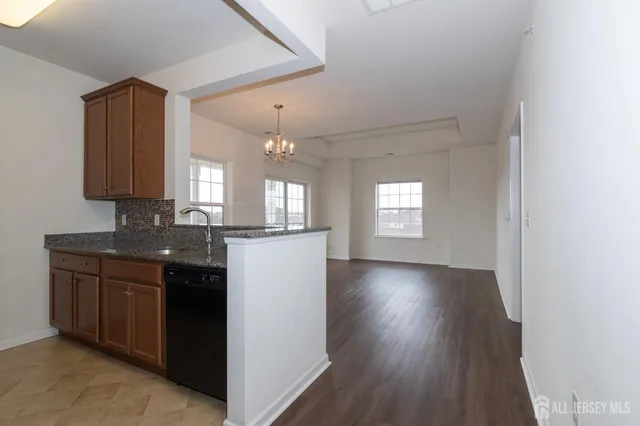 a view of a kitchen counter space and wooden floor
