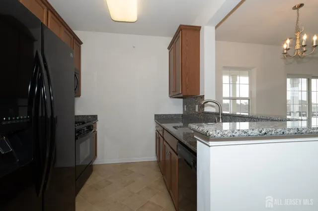 a kitchen with stainless steel appliances granite countertop a sink stove and microwave