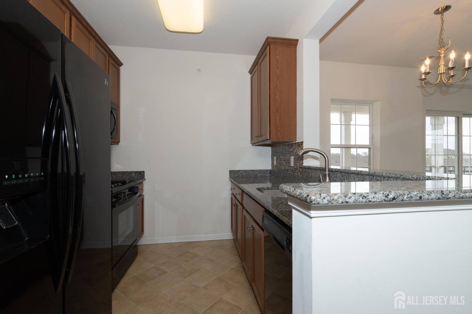 541 East Celebration Way South Plainfield, NJ 07080 - Photo 9 of 35 a kitchen with a sink stove and refrigerator