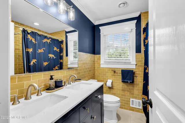 a bedroom with furniture and a large window