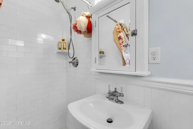 a living room with furniture a window and a flat screen tv