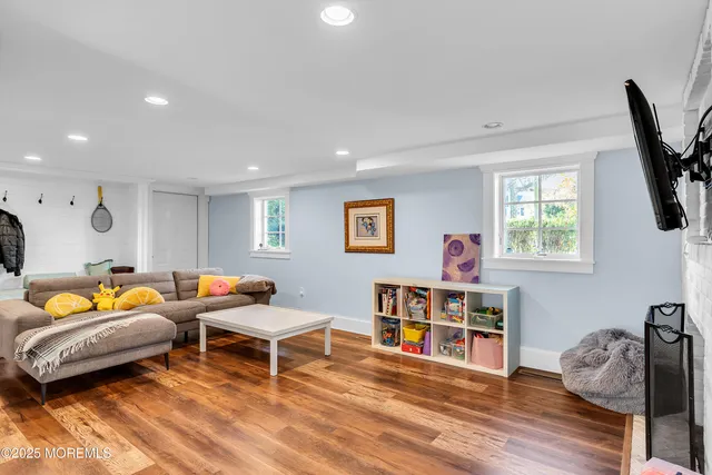 a bedroom with furniture and a wooden floor