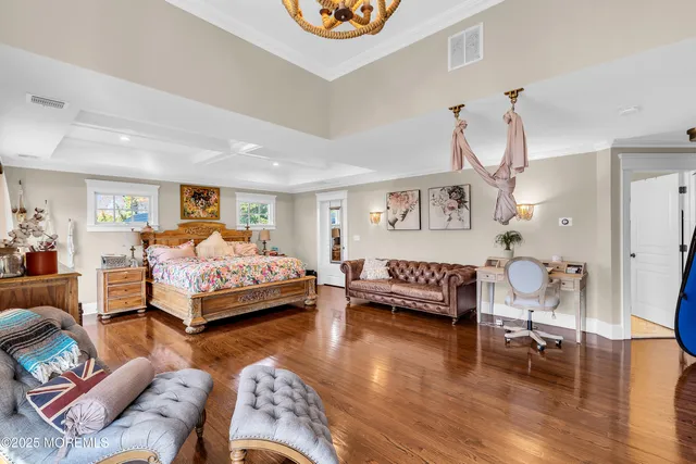 a bedroom with furniture and wooden floor