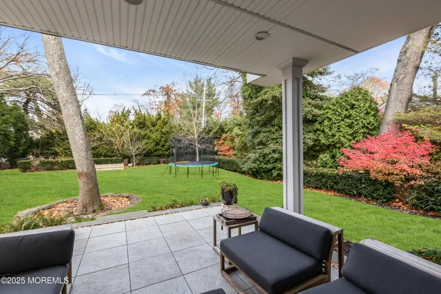 a view of a house with a yard porch and sitting area