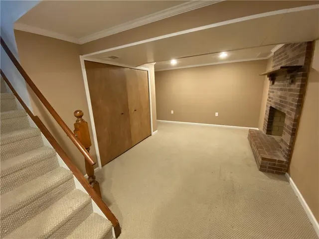 a view of an empty room with a fireplace