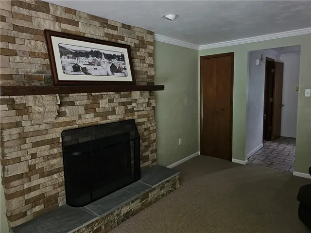 a living room with wall paintings and a fireplace