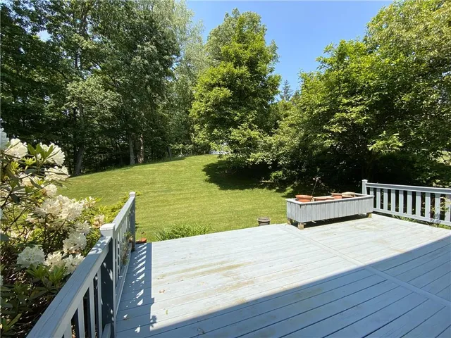 a view of a yard with wooden fence