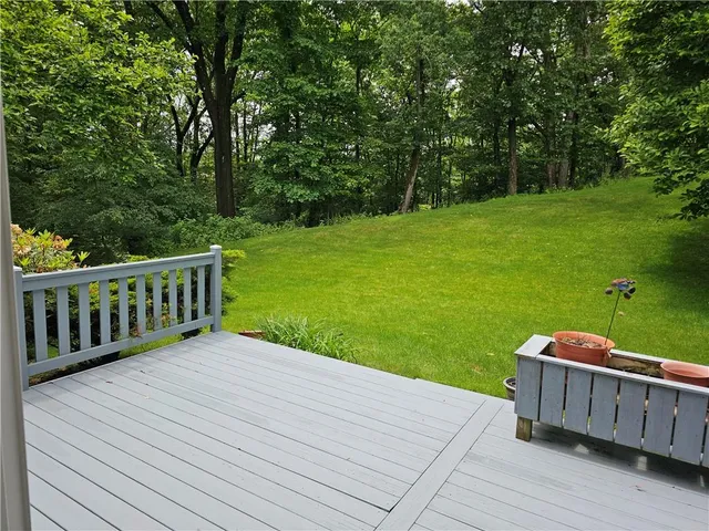 a view of a wooden deck and a yard