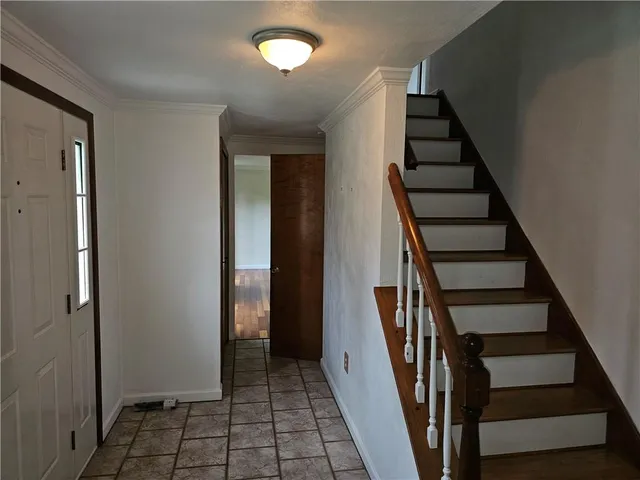a view of entryway with wooden floor and stairs