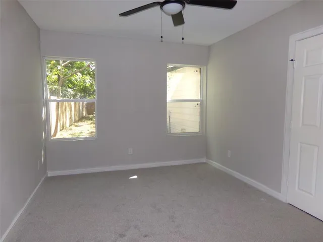 an empty room with windows and natural light