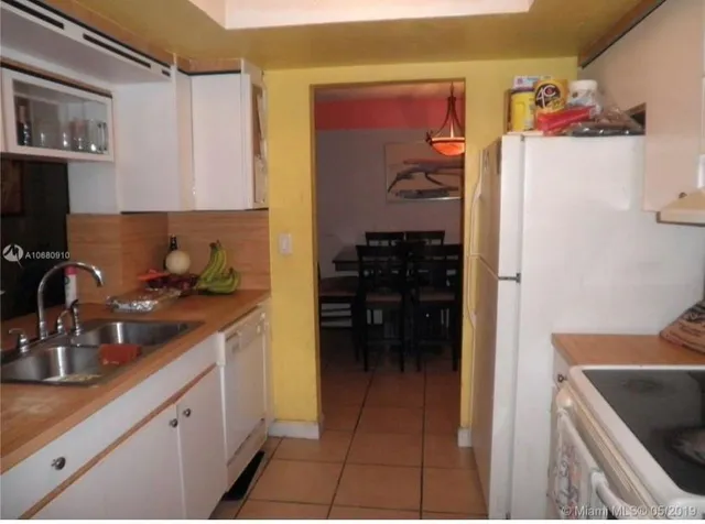 a kitchen with a refrigerator and cabinets