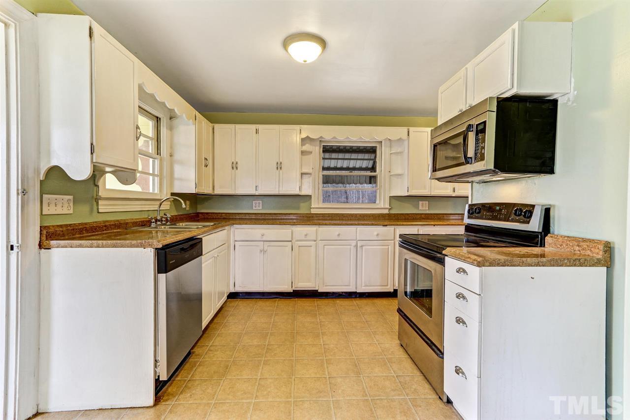 7146 Downsfield Road Randleman, NC 27317 - Photo 14 of 25 a kitchen with stainless steel appliances a stove microwave and sink