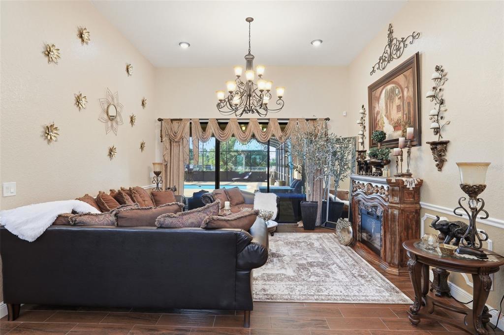 13429 Montevista Road Clermont, FL 34711 - Photo 12 of 89 a living room with furniture and a chandelier
