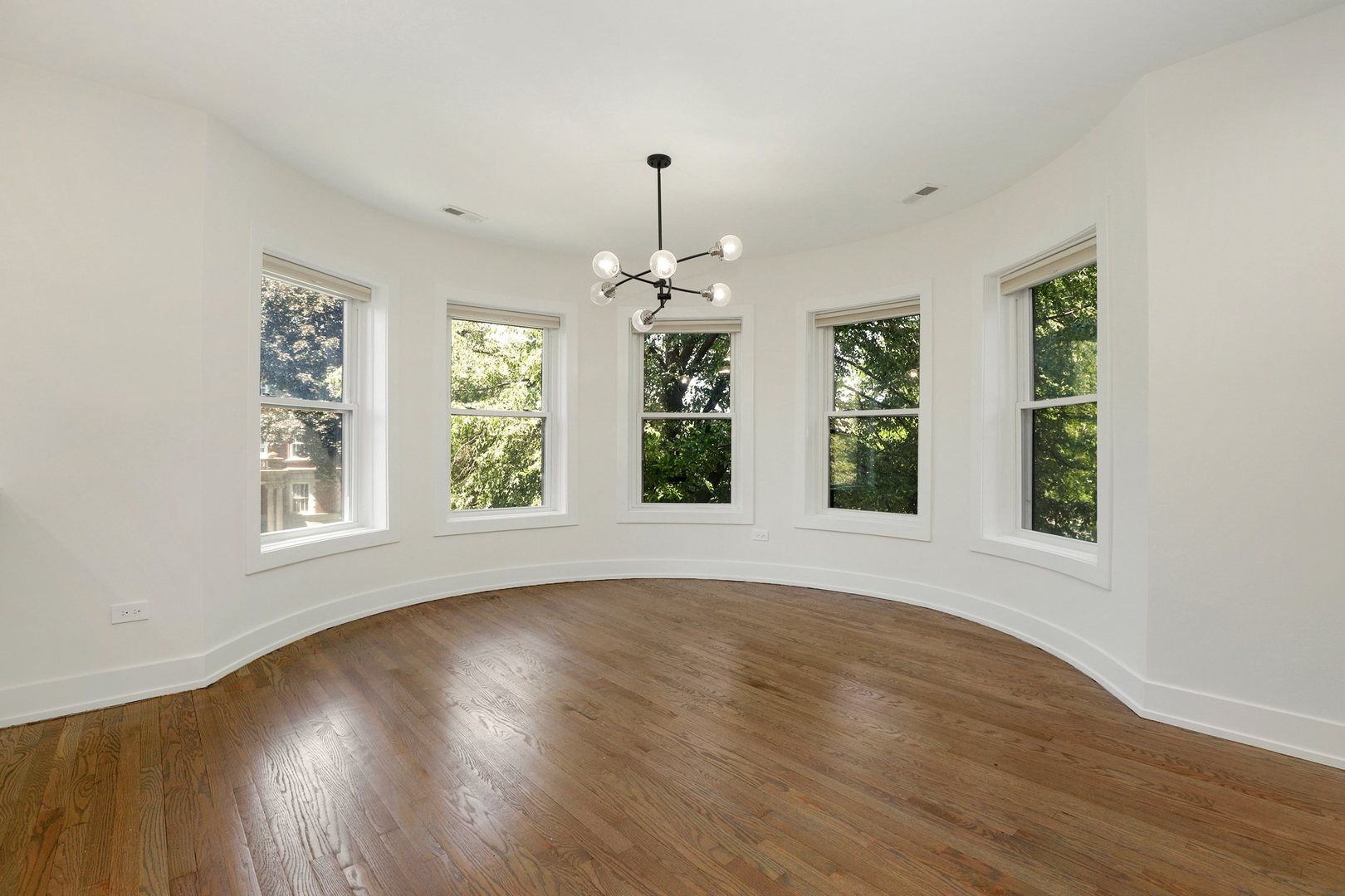4065 North Sheridan Road, Unit 2N Chicago, IL 60613 - Photo 17 of 34 a view of an empty room with wooden floor and a window