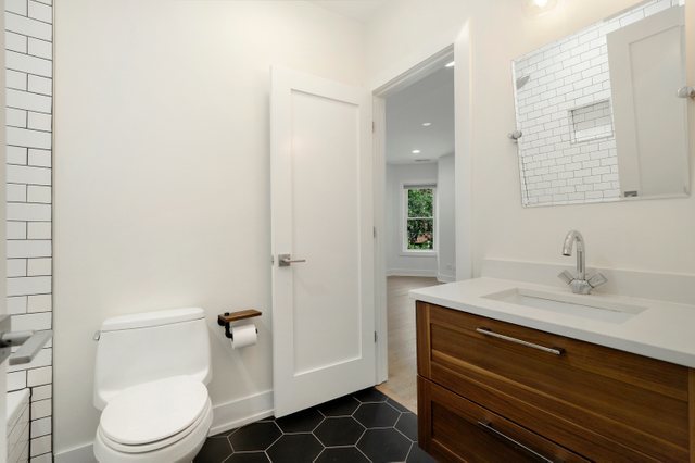 4065 North Sheridan Road, Unit 2N Chicago, IL 60613 - Photo 20 of 34 a bathroom with a granite countertop sink toilet and shower