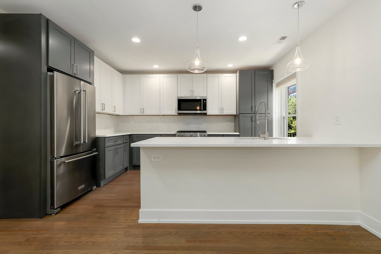 4065 North Sheridan Road, Unit 2N Chicago, IL 60613 - Photo 5 of 34 a kitchen with stainless steel appliances granite countertop a refrigerator a sink a stove and oven