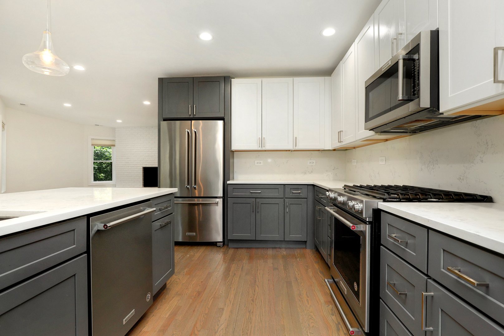 4065 North Sheridan Road, Unit 2N Chicago, IL 60613 - Photo 7 of 34 a kitchen with stainless steel appliances granite countertop a refrigerator stove and microwave