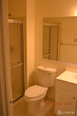 a bathroom with a toilet and a shower