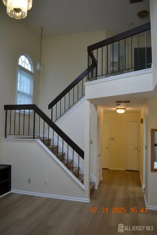a view of staircase with railing and a window