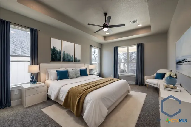 a bedroom with a bed a chandelier and a large window