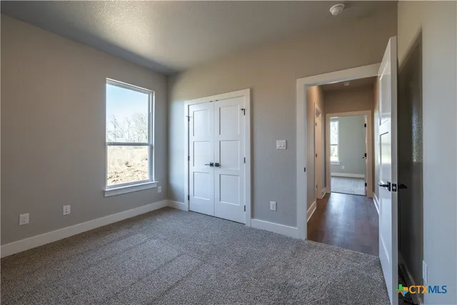a bathroom with a bathtub shower sink vanity mirror and toilet