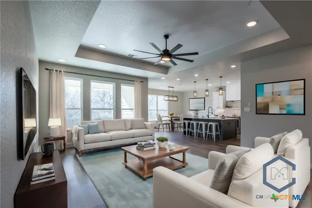 a living room with furniture and a large window