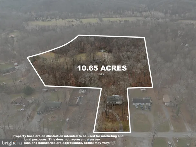 a view of a house with a yard chairs and iron fence