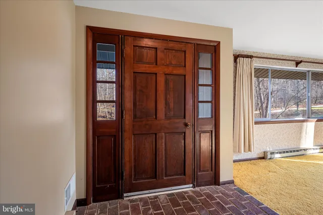 a view of a kitchen with a sink and refrigerator