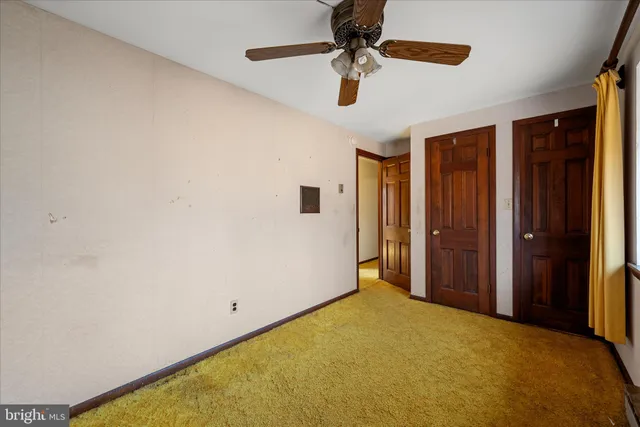 a view of a wooden bench with trees in the background