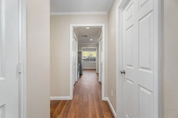 a view of a hallway with wooden floor