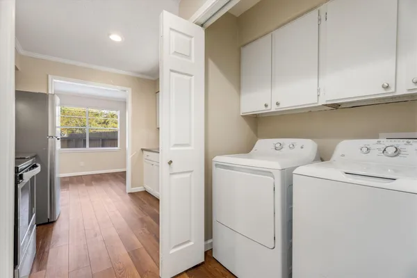 a view of washer and dryer with wooden floor