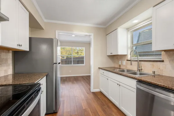 a kitchen with a sink stove and cabinets