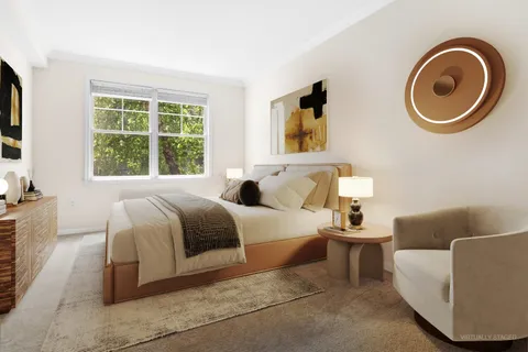 a spacious bedroom with a bed and a couch