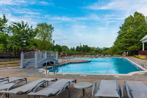 swimming pool view with a seating space