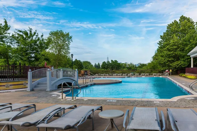 swimming pool view with a seating space