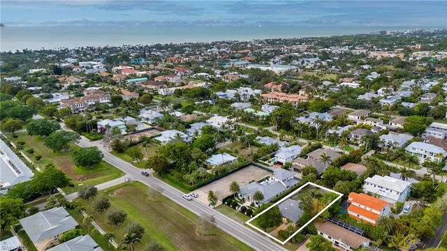 an aerial view of multiple houses with a yard
