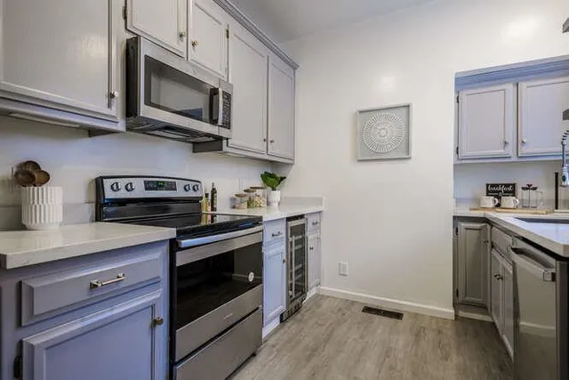 a kitchen with stainless steel appliances granite countertop a stove a microwave and cabinets