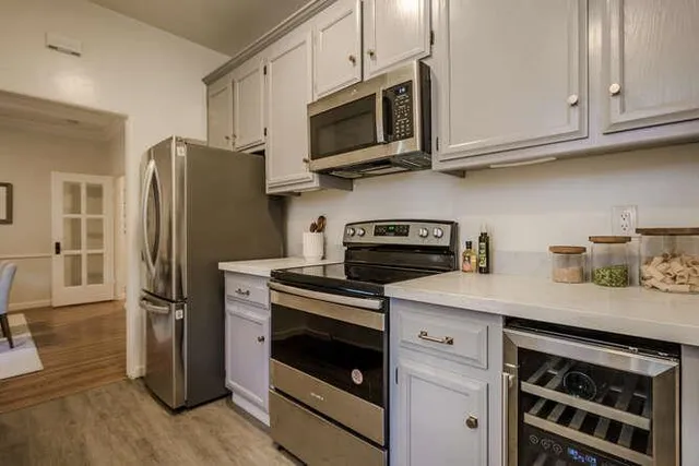 a kitchen with stainless steel appliances granite countertop a refrigerator stove and microwave
