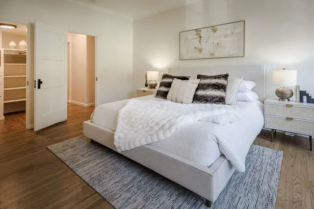 a bed room with a bed and a night stand