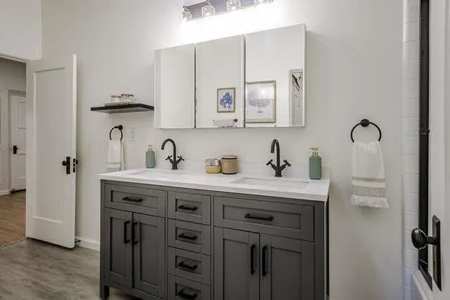 a spacious bathroom with a sink and a mirror