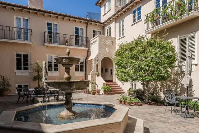 a front view of a house with fountain