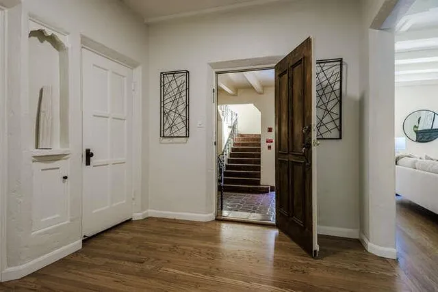 a view of an entryway with wooden floor