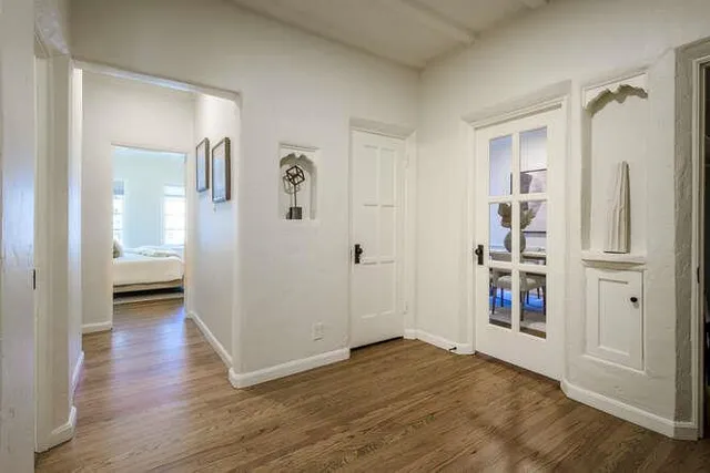 a view of walk in closet with hardwood floor and a bathroom